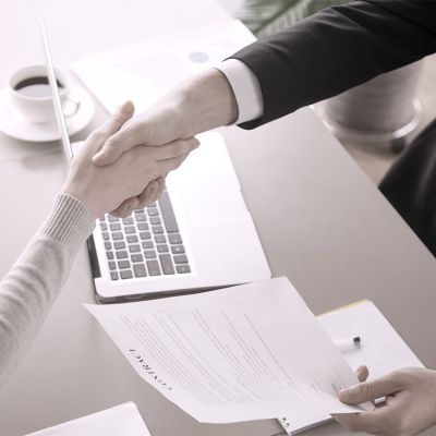 Business man and woman resolving a conflict and shaking hands